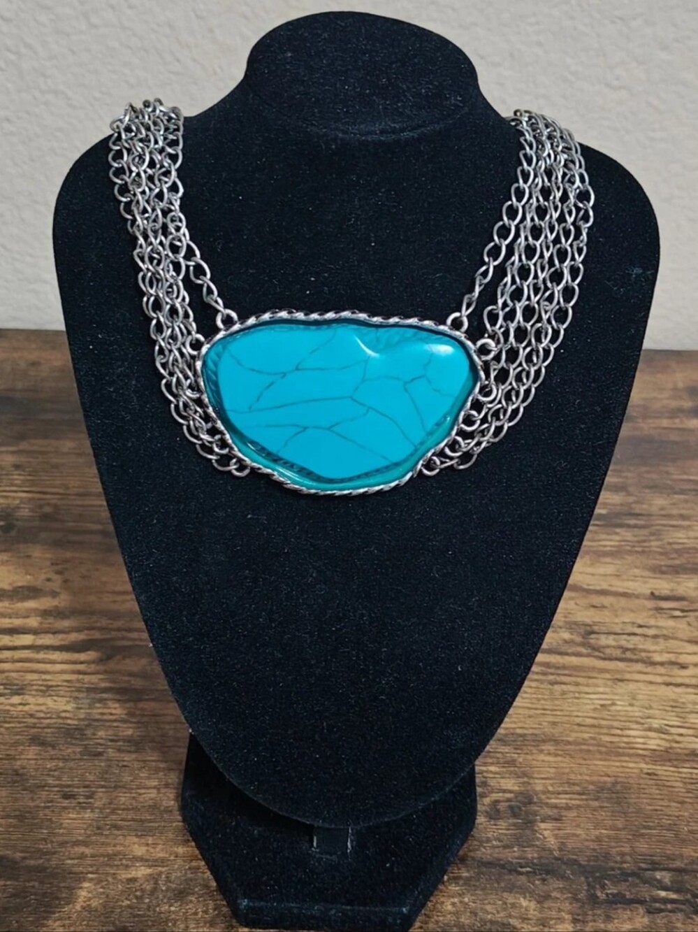 Silver Tone Multi Strand Chain Statement Necklace With a Faux Turquoise Stone